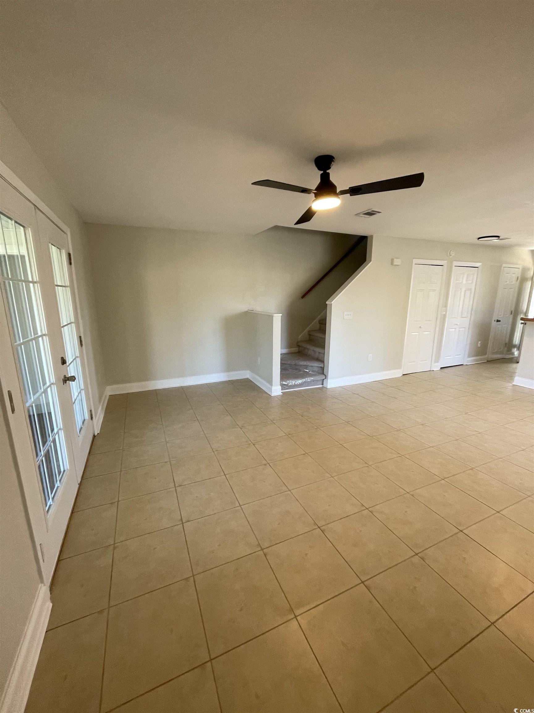 4641 Socastee Boulevard, Unit E1 Myrtle Beach, SC 29588 - Photo 19 of 20 Unfurnished bedroom featuring light tile patterned flooring, ceiling fan, and french doors