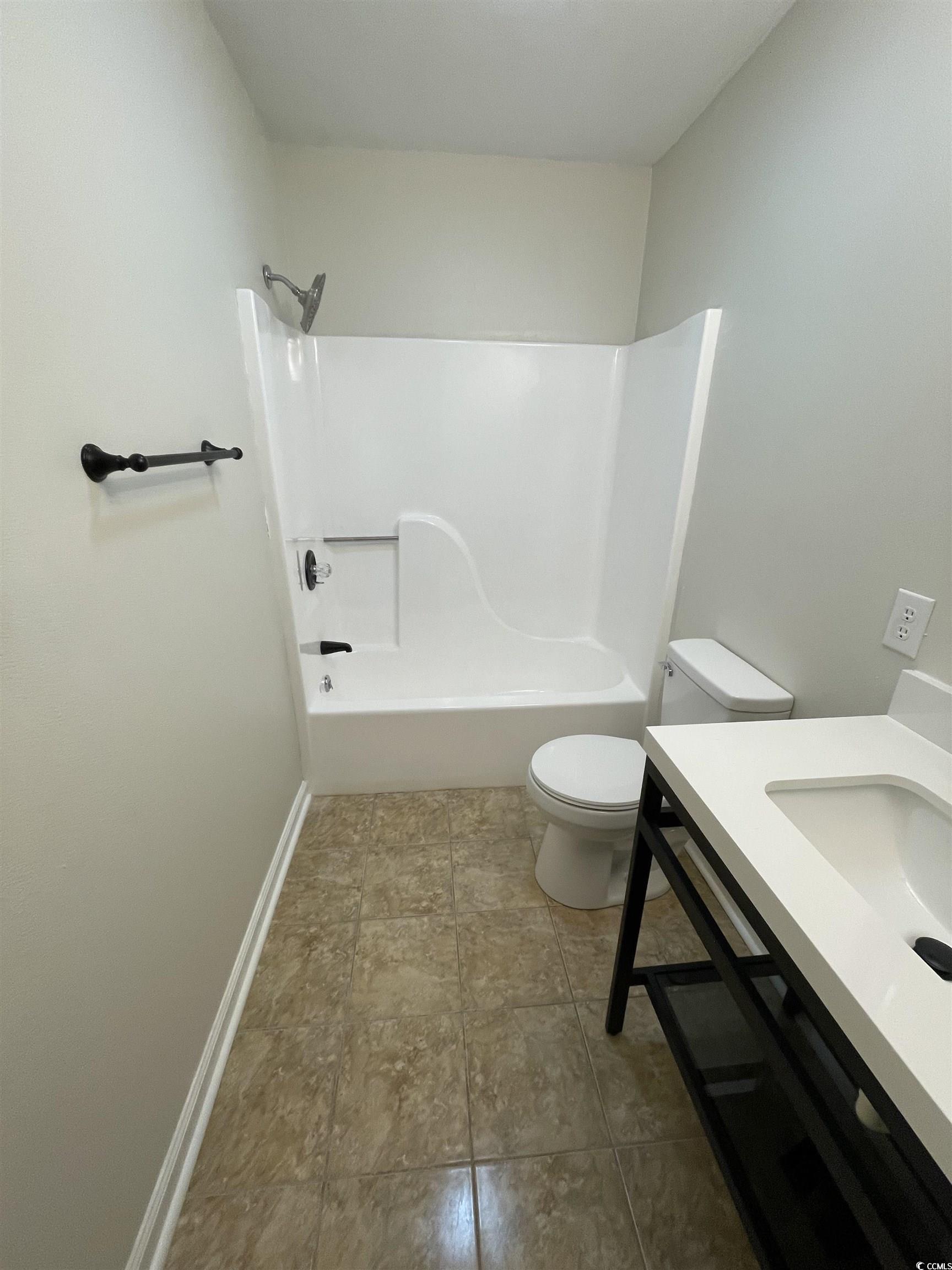 4641 Socastee Boulevard, Unit E1 Myrtle Beach, SC 29588 - Photo 7 of 20 Bathroom with vanity, shower / bathtub combination, and light tile patterned flooring
