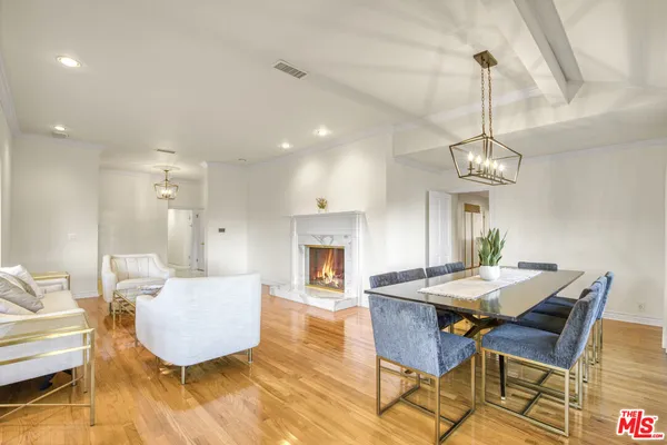 a view of a dining room with furniture wooden floor and chandelier
