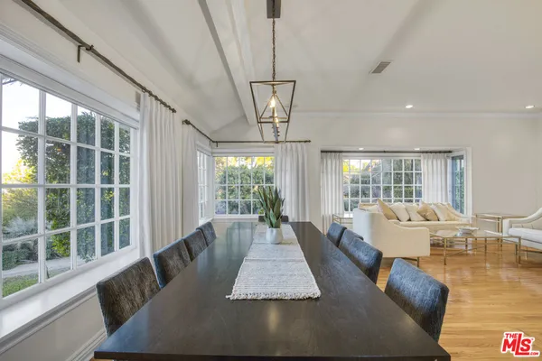 a living room with large window and a table