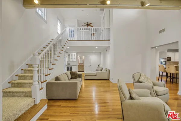 a living room with furniture and stairs