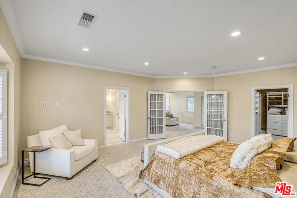 a spacious bedroom with a large bed and a large window