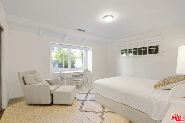 a bedroom with a bed and a couch