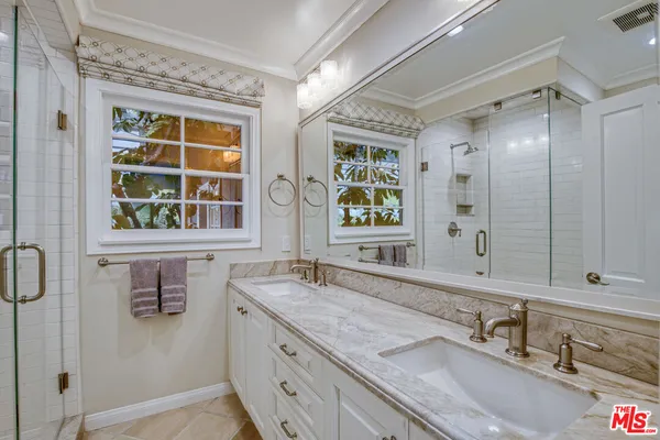a bathroom with a granite countertop sink mirror and double