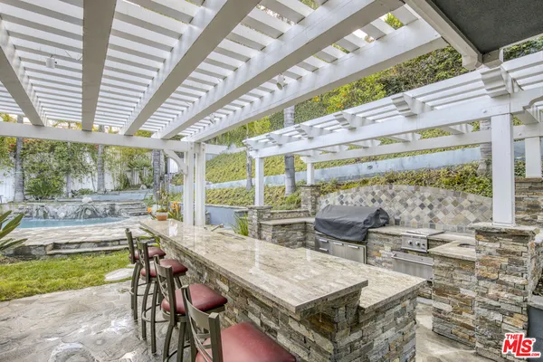 a view of a patio with table and chairs and potted plants
