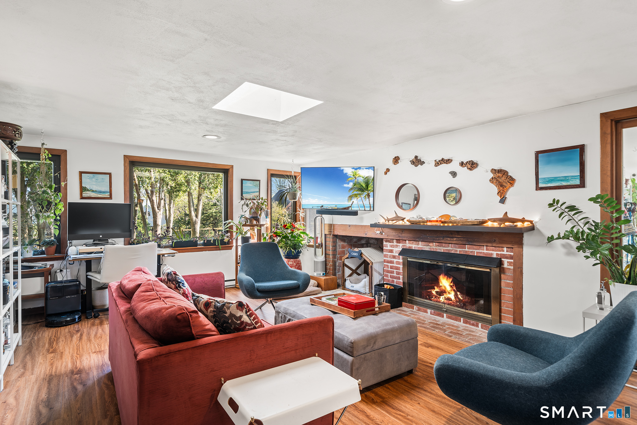 6 Shore Road Waterford, CT 06385 - Photo 12 of 40 a living room with furniture a fireplace and a large window