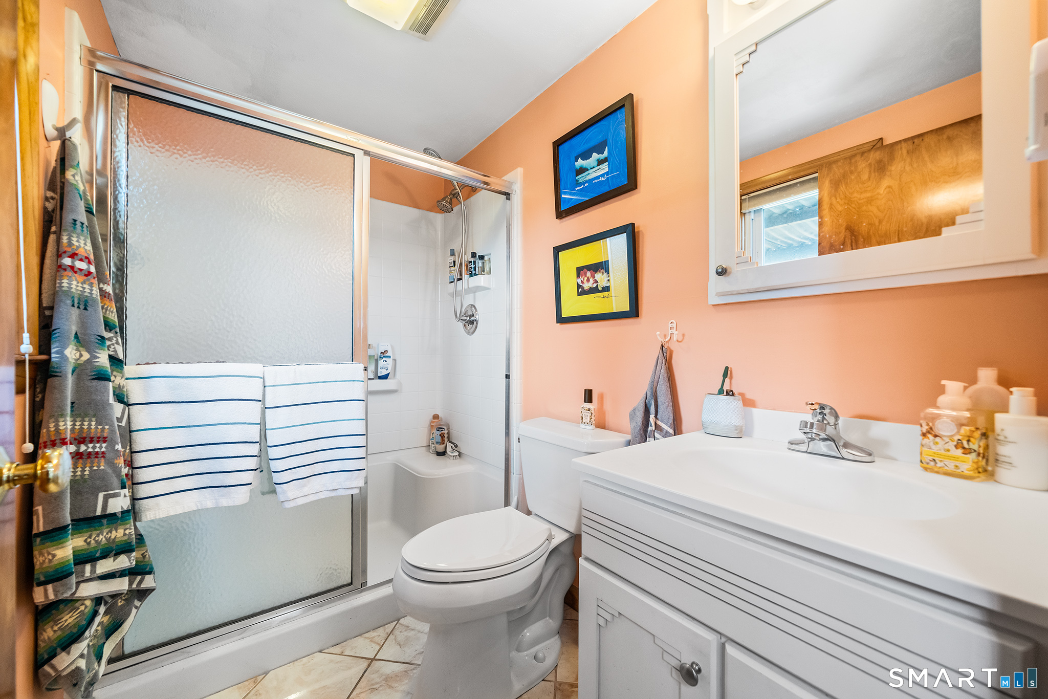 6 Shore Road Waterford, CT 06385 - Photo 15 of 40 a bathroom with a sink a toilet and shower curtain