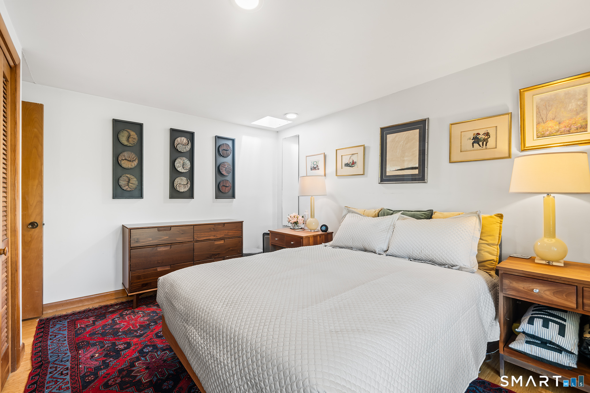 6 Shore Road Waterford, CT 06385 - Photo 23 of 40 a bedroom with a bed and wooden floor