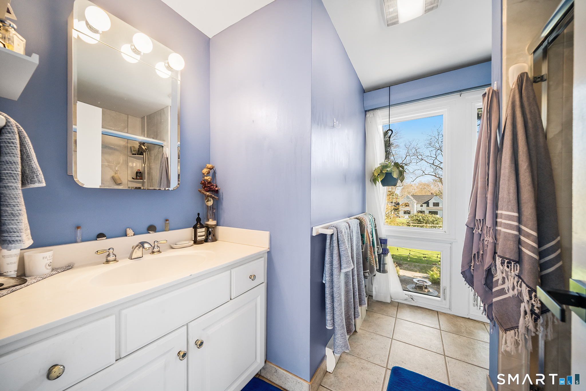 6 Shore Road Waterford, CT 06385 - Photo 27 of 40 a bathroom with a sink a vanity and a mirror