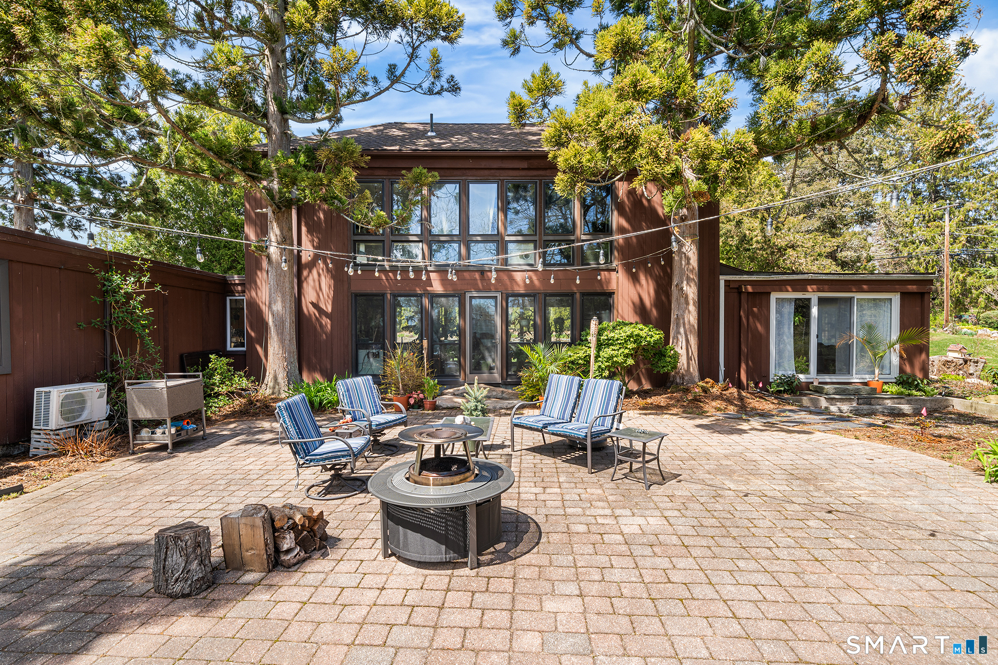 6 Shore Road Waterford, CT 06385 - Photo 31 of 40 a view of the patio with dining table and chairs under an umbrella
