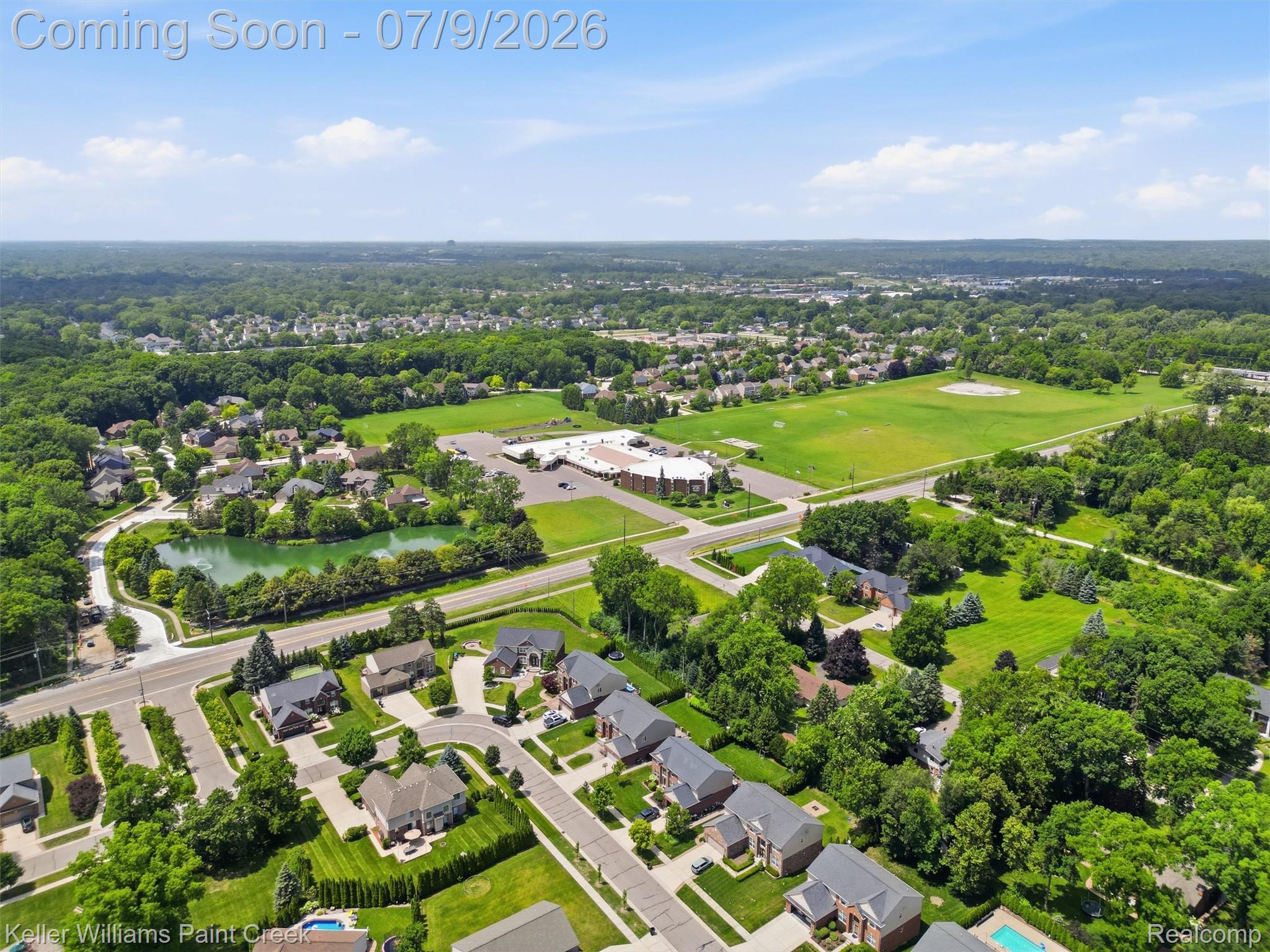 846 Monterey Ln. Rochester, MI 48307 - Photo 46 of 52 Aerial perspective showcasing a residential community with mature trees, green spaces, and a pond