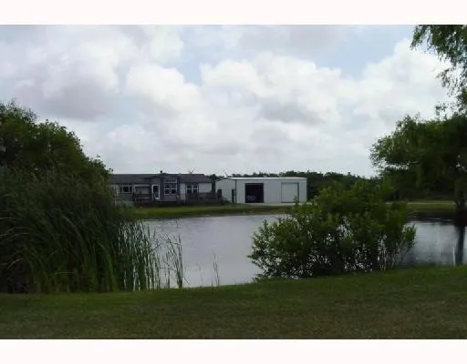 a view of a lake with a house in background