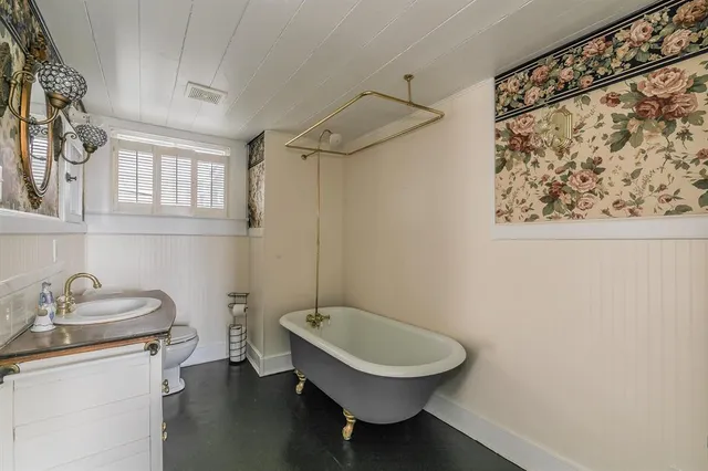 a bathroom with a granite countertop sink toilet a mirror and a shower