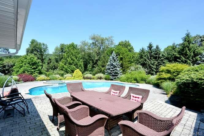 89 Spook Rock Road Suffern, NY 10901 - Photo 37 of 44 a view of a dinning table and chairs in patio