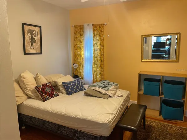 a bedroom with a bed and a couch