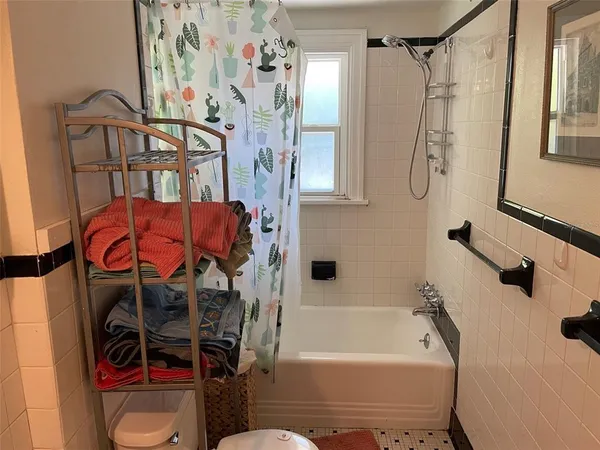 a bathroom with a bathtub a shower and a sink