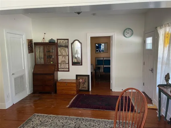 a view of hall way with furniture and wooden floor