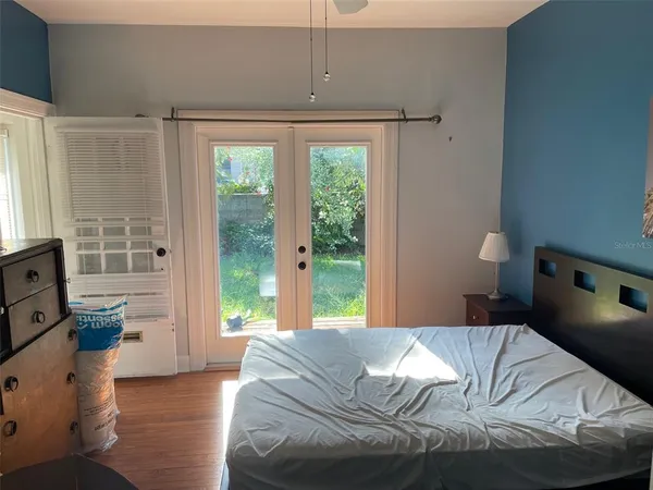 a bedroom with a bed and a window