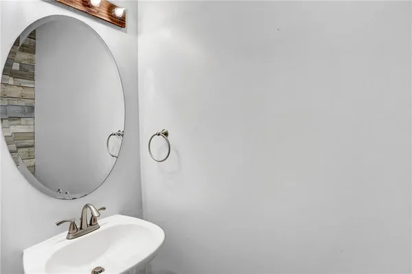 an empty room with windows and ceiling fan