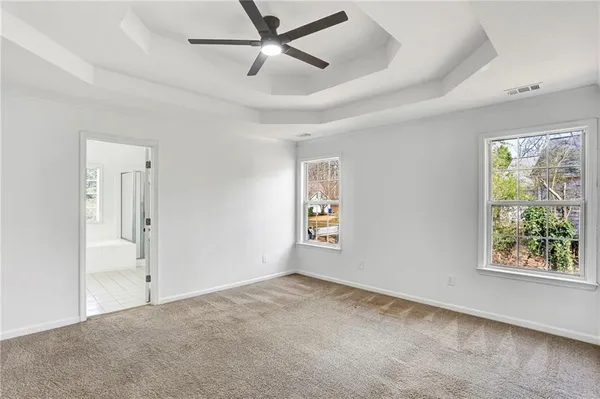 a view of a room with a ceiling fan