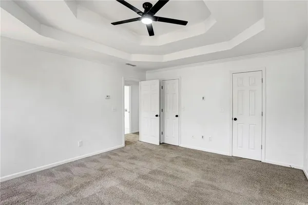 a spacious bathroom with a bathtub a sink and a large mirror