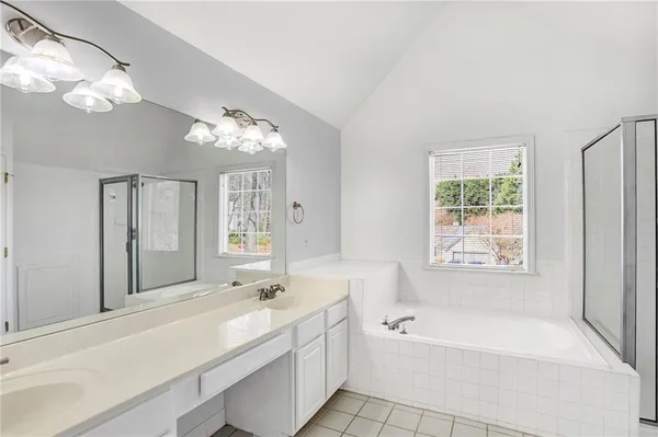 a white bath tub sitting next to a white sink