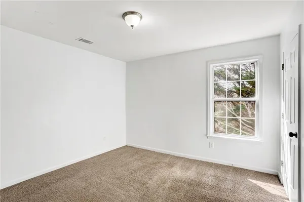 a bathroom with a tub a sink and a mirror