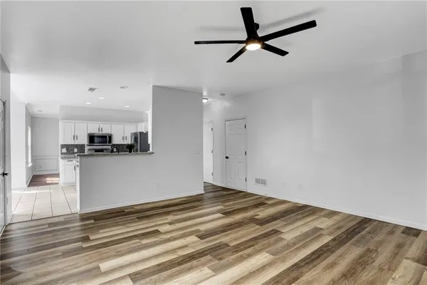 a view of kitchen with wooden floor and window