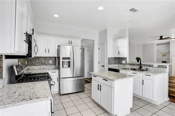 a kitchen with a stove sink and refrigerator