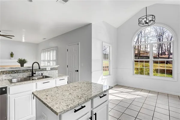a kitchen with a sink stove and cabinets