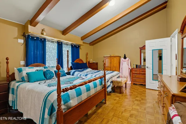 a bedroom with furniture and a large window