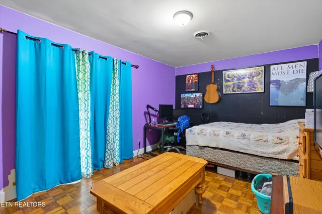 a bedroom with furniture and a window