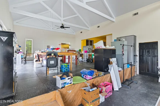 a living room with lots of furniture and a view of kitchen