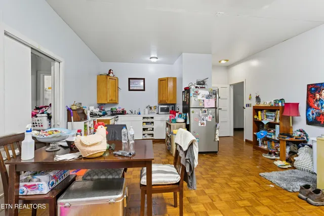 a living room with furniture a rug and white walls