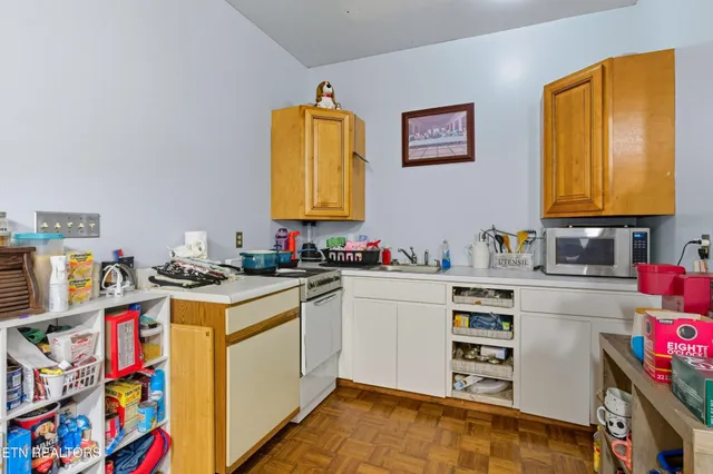 a view of a kitchen with appliances and a dining table