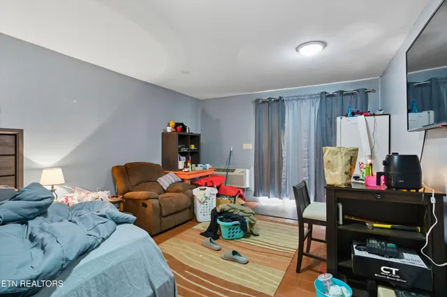 a living room with furniture and a flat screen tv