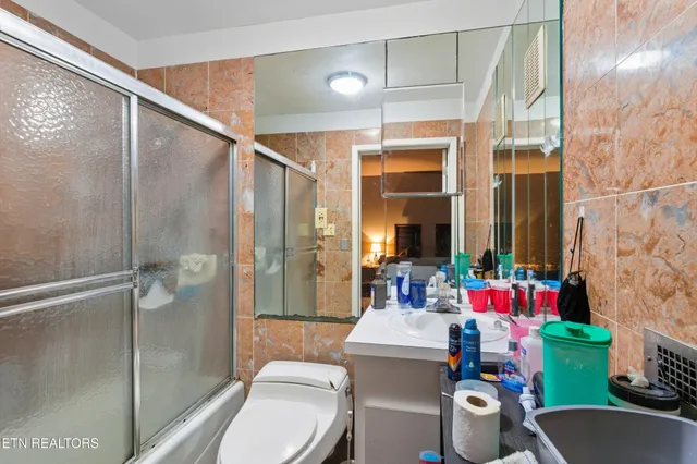 a bathroom with a sink toilet and shower