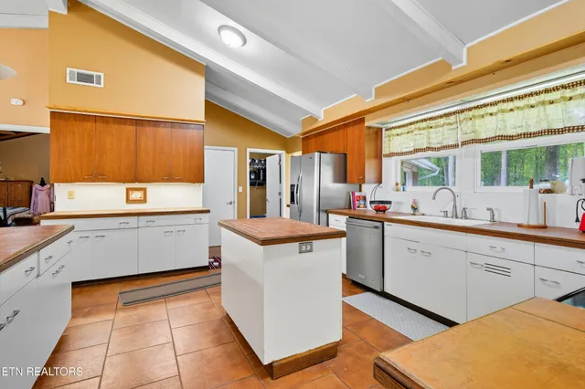 a kitchen that has a sink and a stove in it