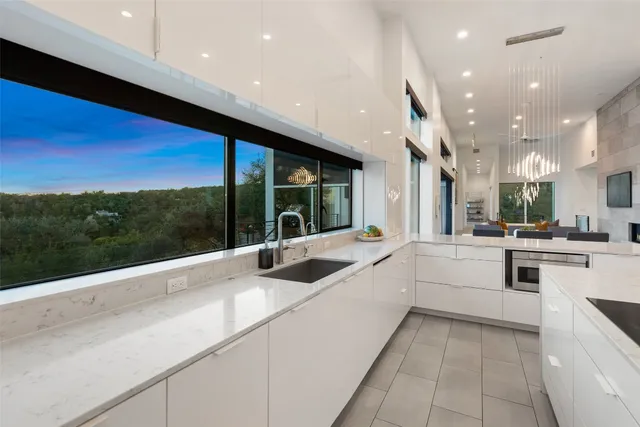 a kitchen with a sink and large window