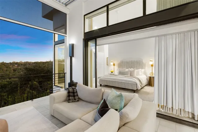 a living room with furniture and a floor to ceiling window