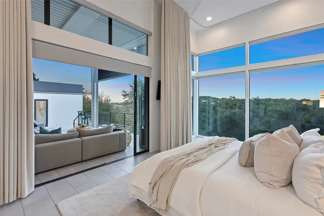 a bedroom with a large bed and a large window