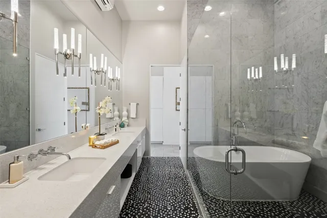 a bathroom with a tub a sink and a shower