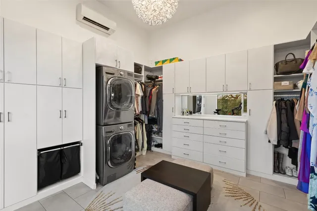 a view of a bedroom with washer and dryer