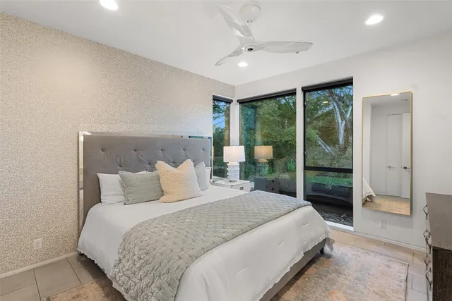 a bedroom with a large bed and a large window