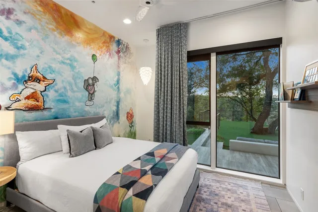 a bedroom with a bed and a painting on the wall