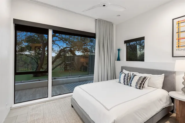 a bedroom with a large bed and a painting on the wall