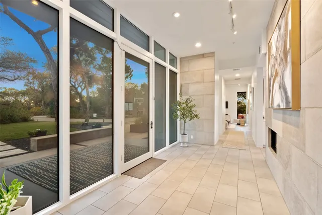 a view of a hallway with wooden floor and a glass door