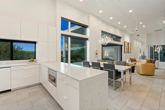 a large white kitchen with a large window