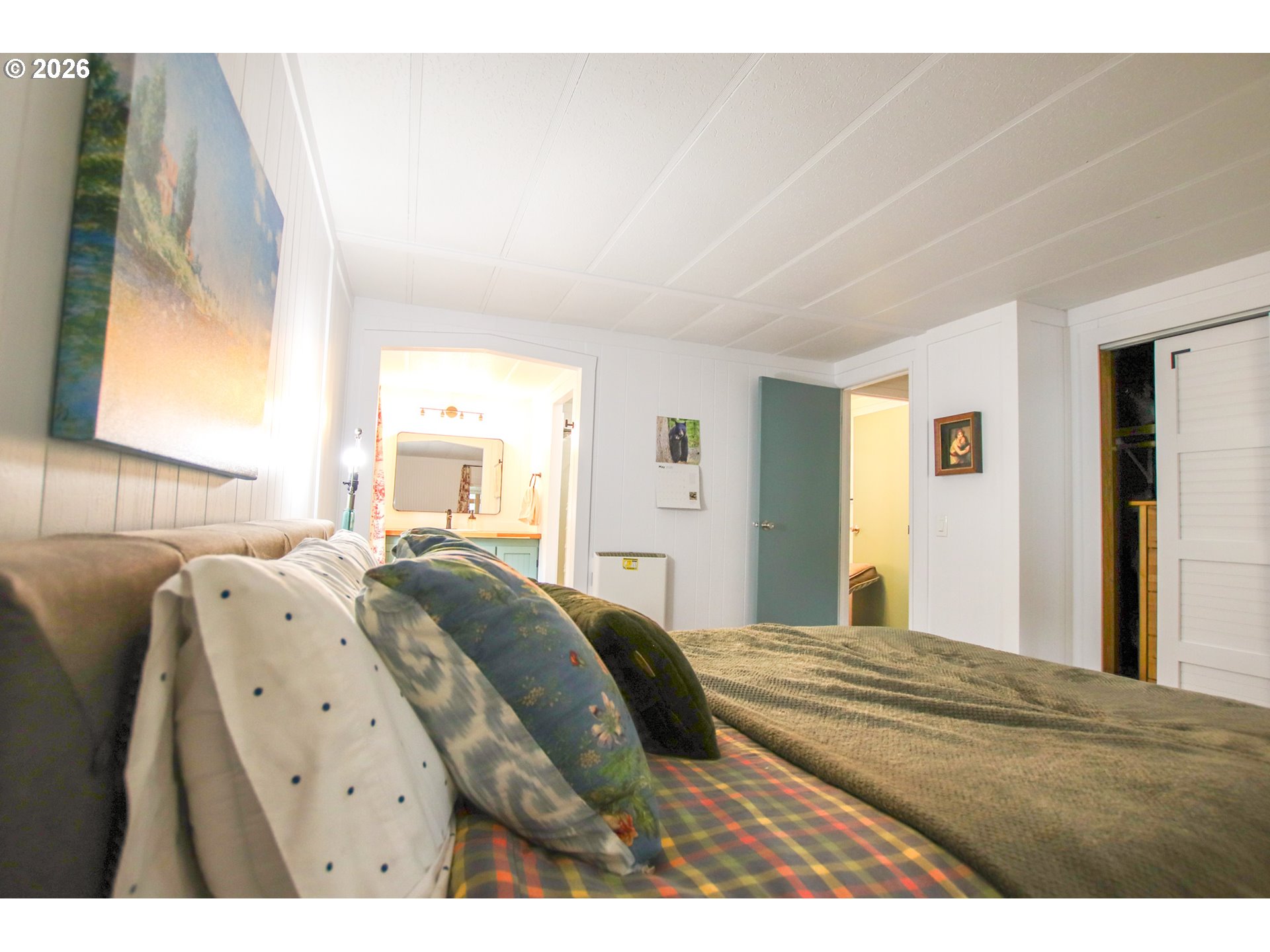 1431 Maple Street Florence, OR 97439 - Photo 28 of 43 a bedroom with a bed with wooden floor