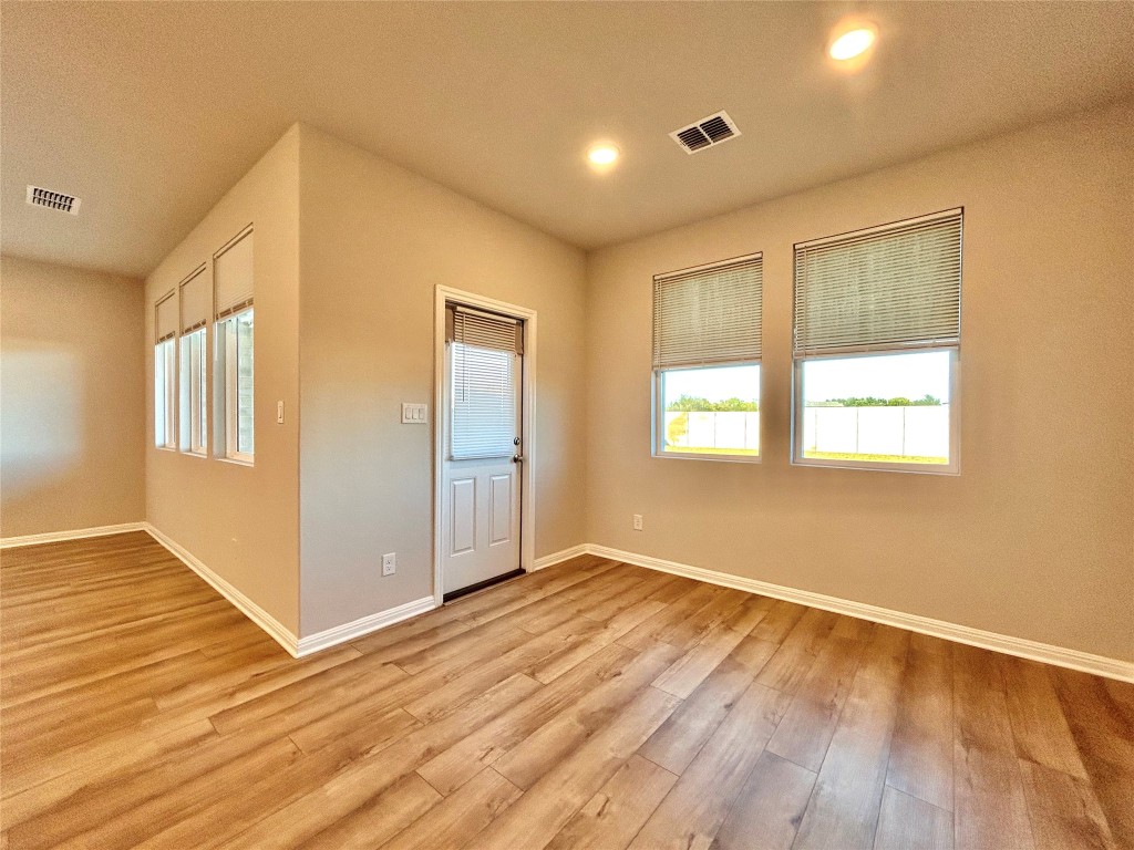 13104 Zumpango Trace Manor, TX 78653 - Photo 11 of 37 Spare room with light wood-style flooring and baseboards
